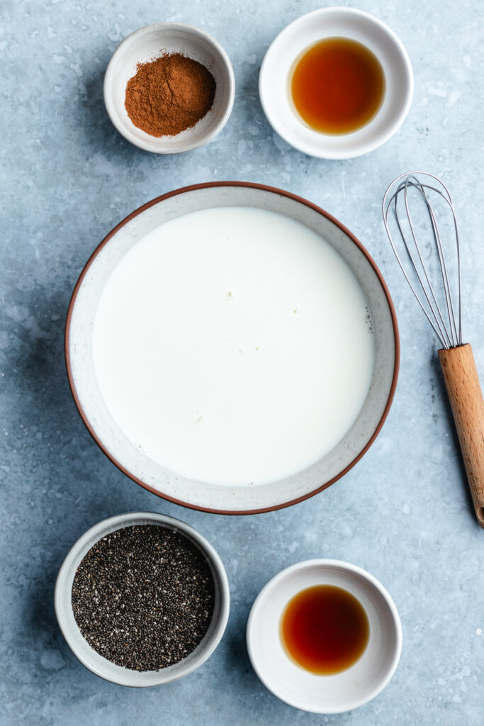 The milk in a bowl with the other ingredients in small bowls.
