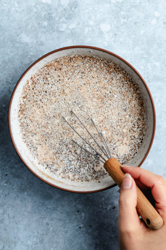 Whisking together the ingredients in a bowl.