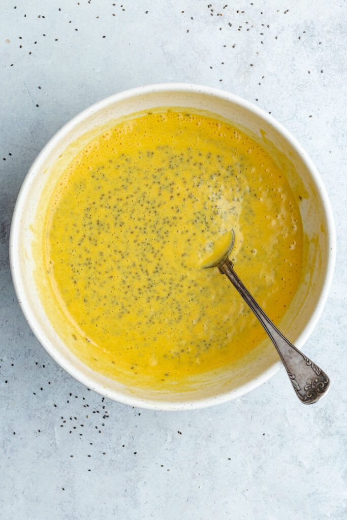 The chia pudding stirred together in a bowl with a spoon.