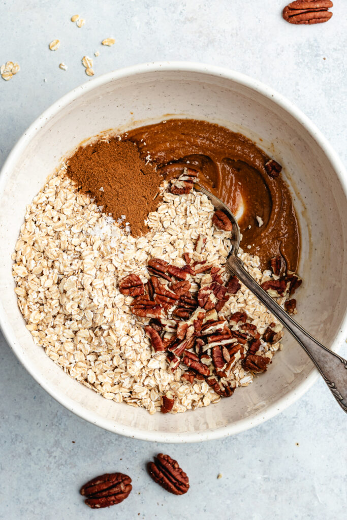 The added oats, pecans, cinnamon and salt to the bowl.