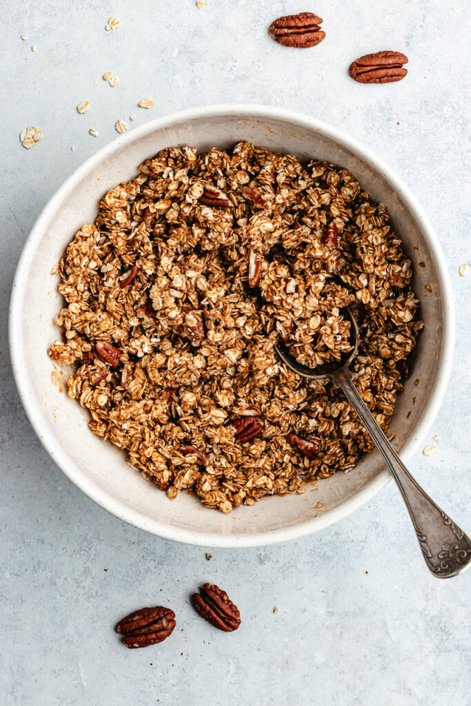 The granola in the mixing bowl.