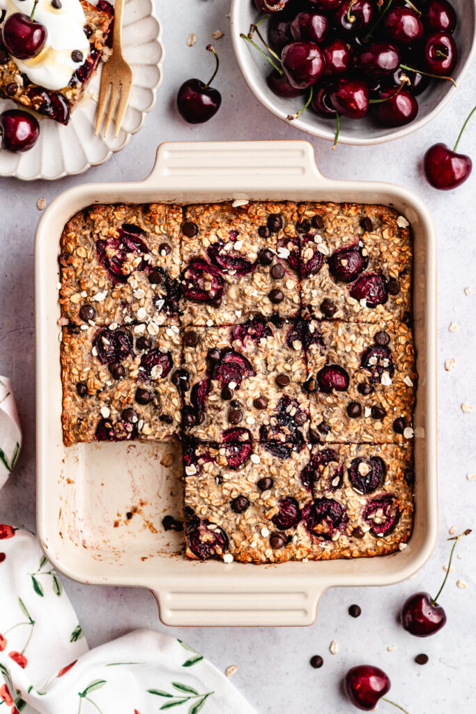 The baked oatmeal in the baking dish, cut into pieces.