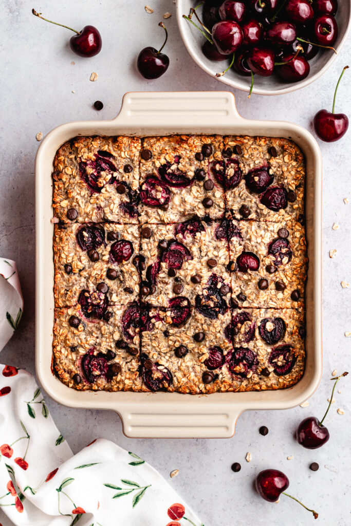 The baked oatmeal in the baking dish, cut into pieces.