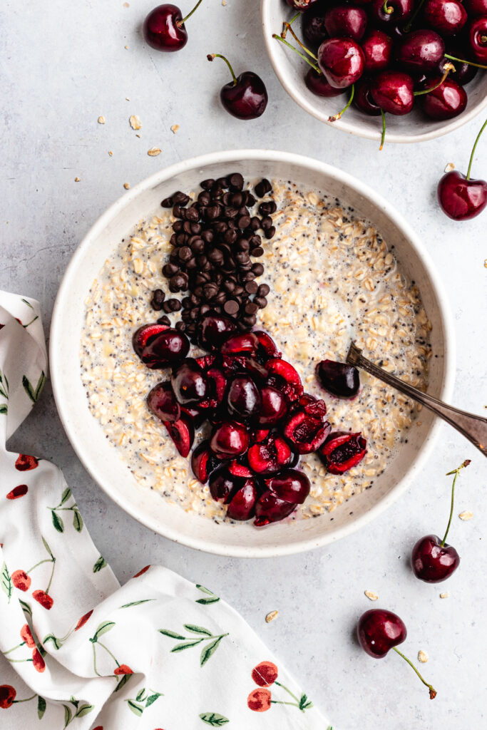 The added chocolate chips and cherries to the bowl.