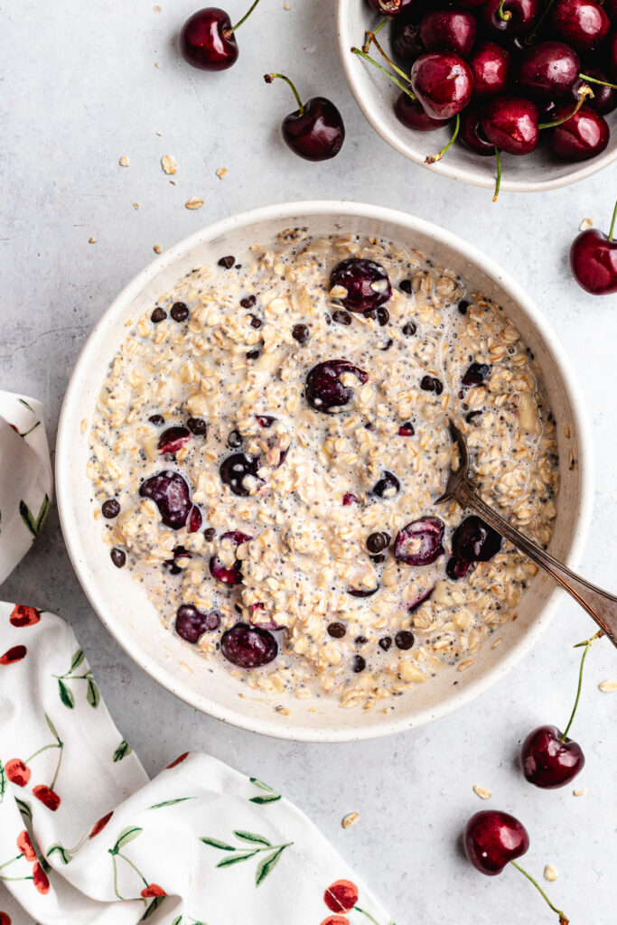 The oat mixture in a mixing bowl with a spoon.