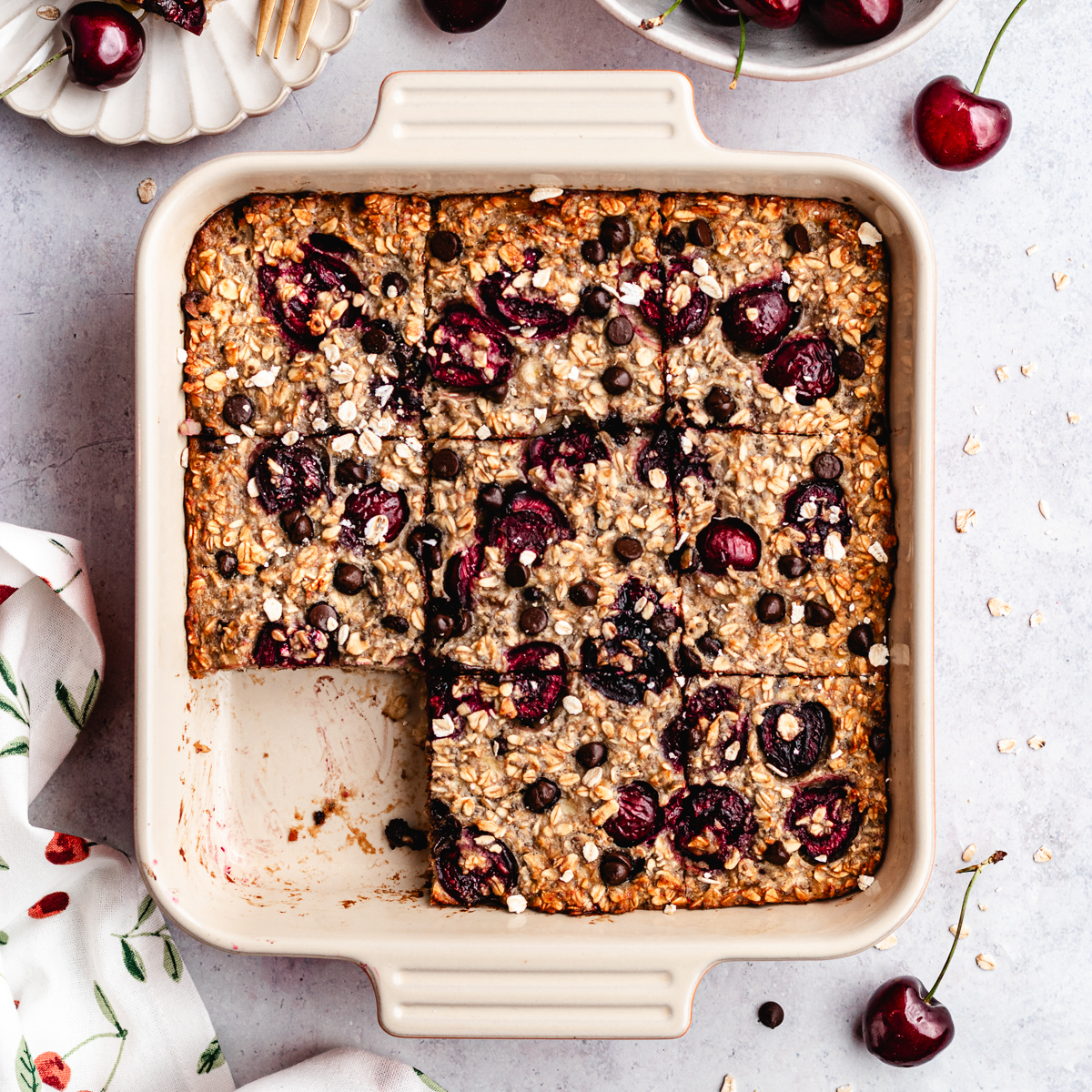 The baked oatmeal in the baking dish, cut into pieces.