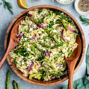 The salad in a bowl topped with fresh dill and feta cheese.