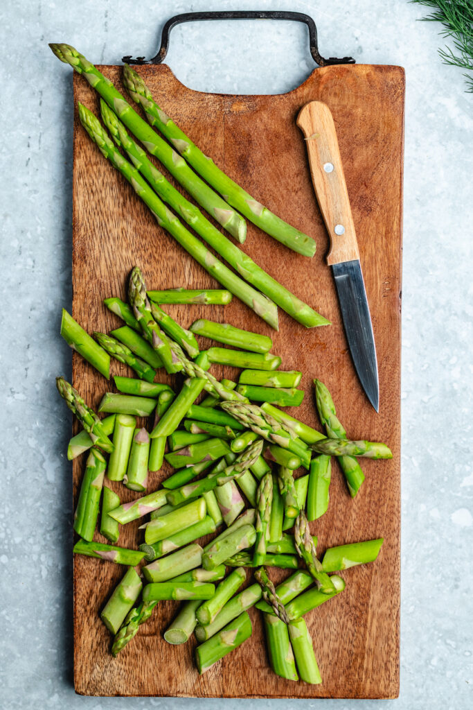 The chopped asparagus on the cutting board.