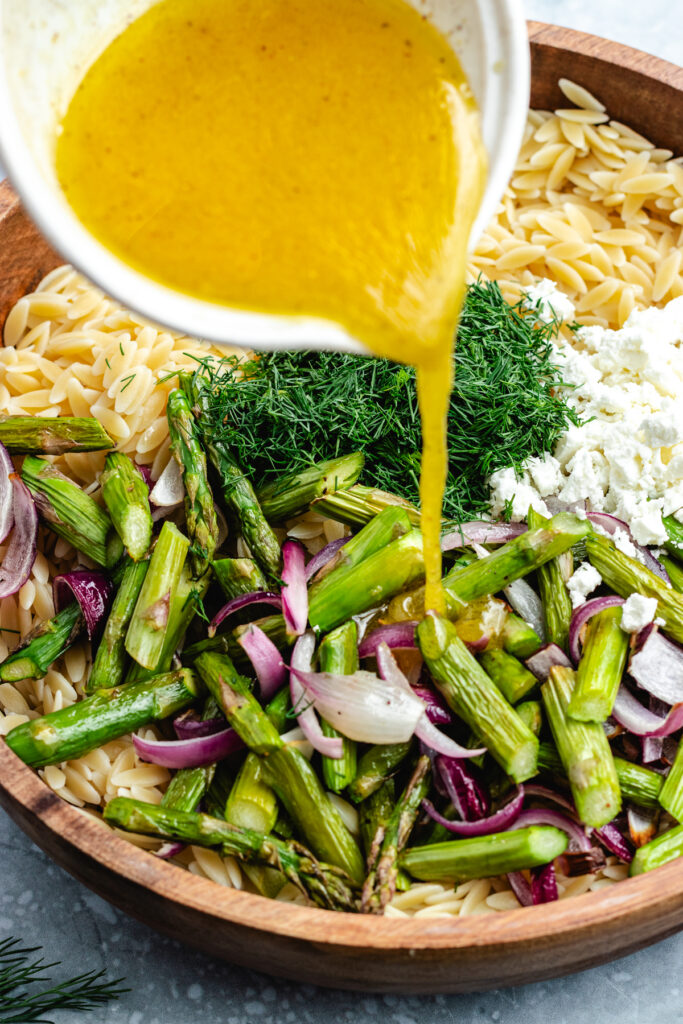 Pouring the dressing over the salad.