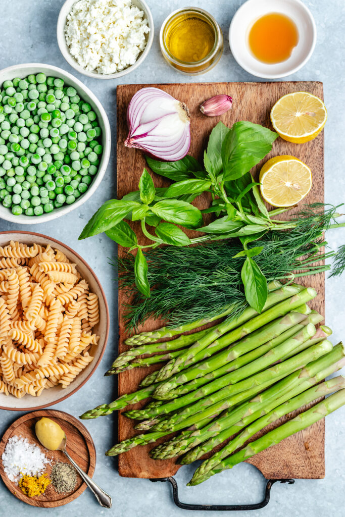 The ingredients for the salad on a cutting board and in small bowls.