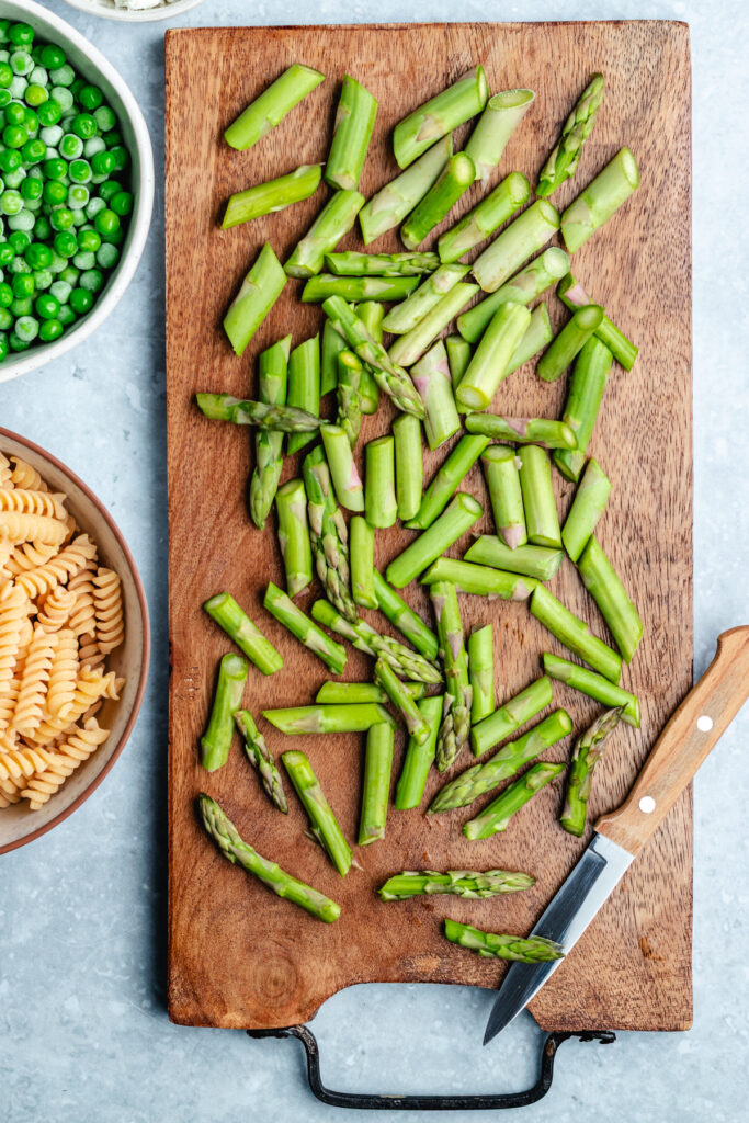The chopped asparagus on a cutting board.
