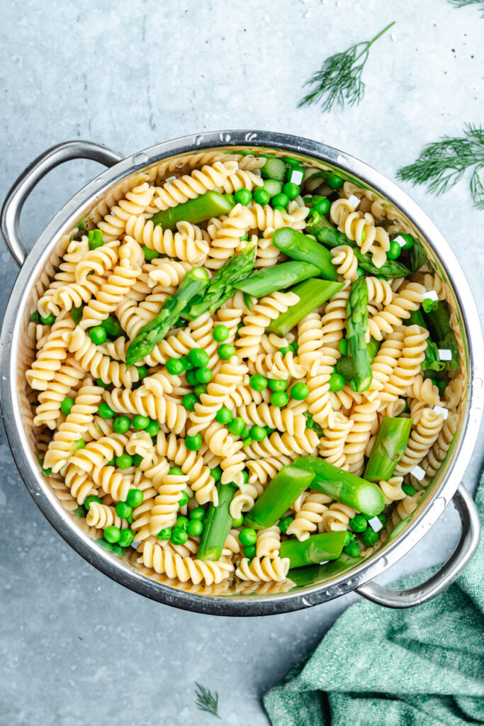 The cooked pasta, peas and asparagus.