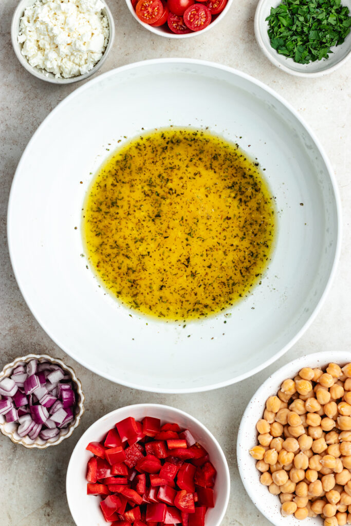 The dressing in a salad bowl.