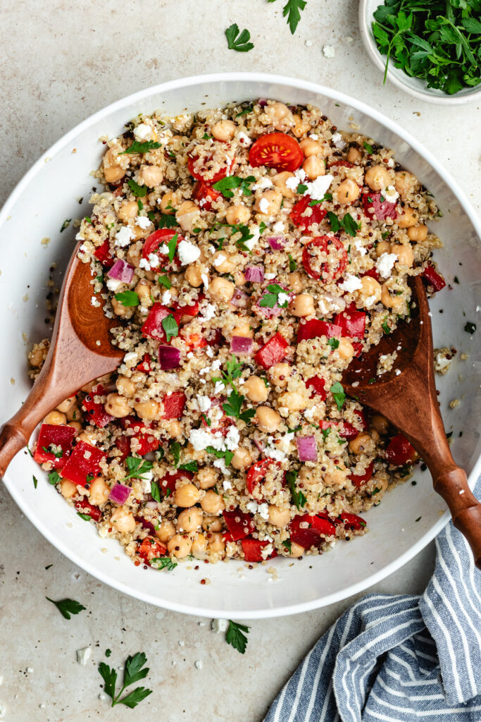 Tossing together the salad in the bowl.