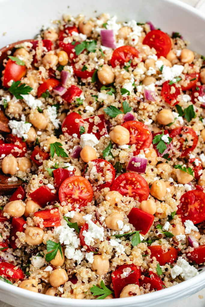 The salad in a large salad bowl topped with fresh parsley.