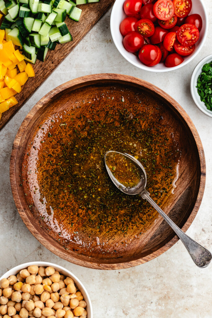 The dressing in a salad bowl.