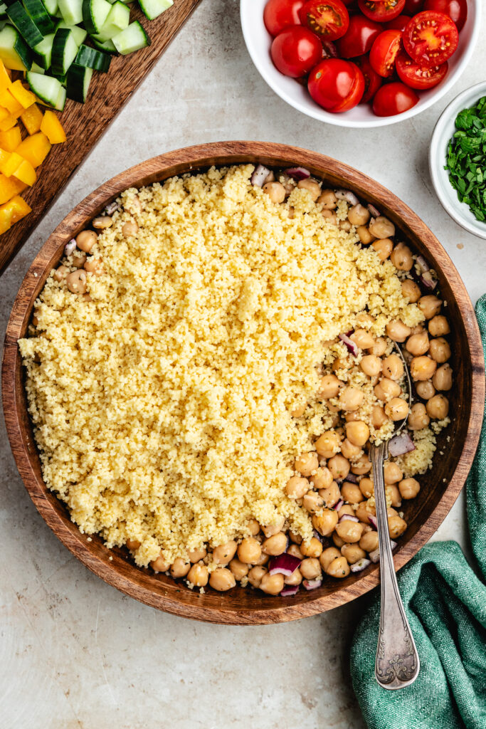 The couscous added to the salad bowl.
