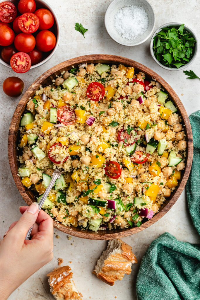 Stirring together the salad with a spoon.