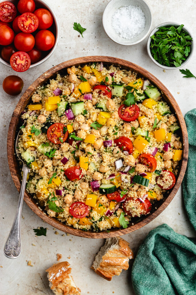 The salad in a wooden bowl with a spoon.