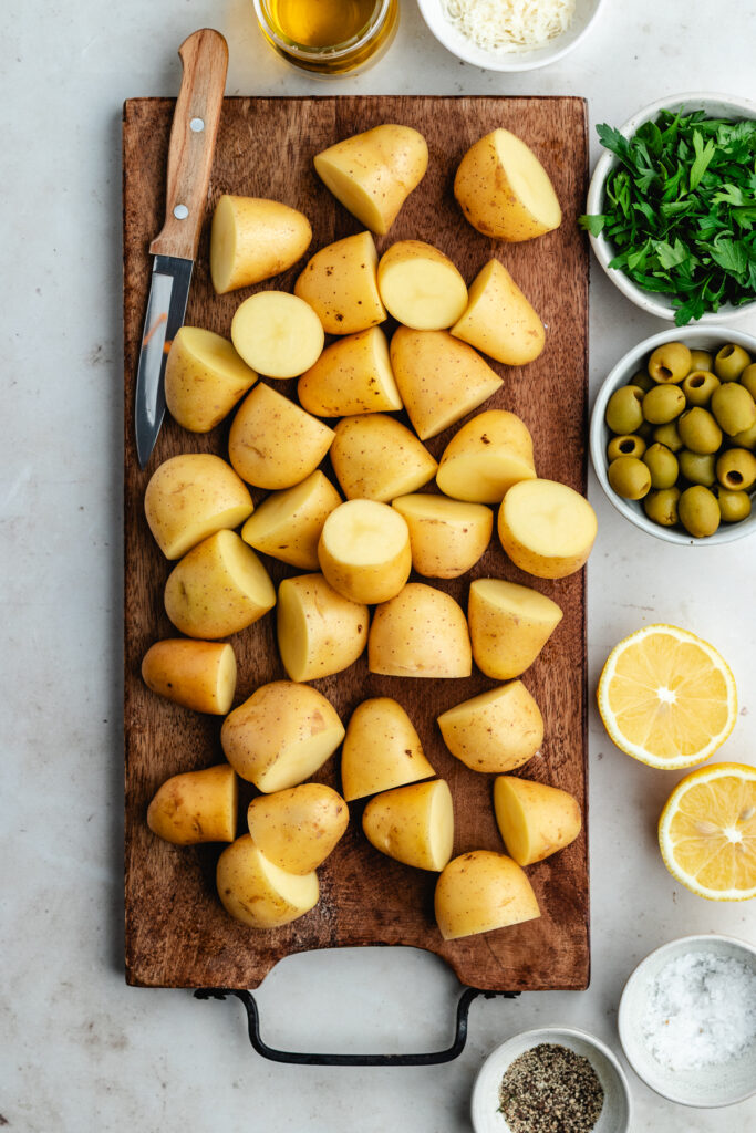 The chopped potatoes on the cutting board.