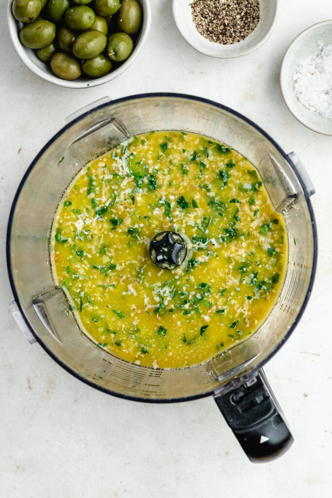 The blended olive dressing in the food processor.