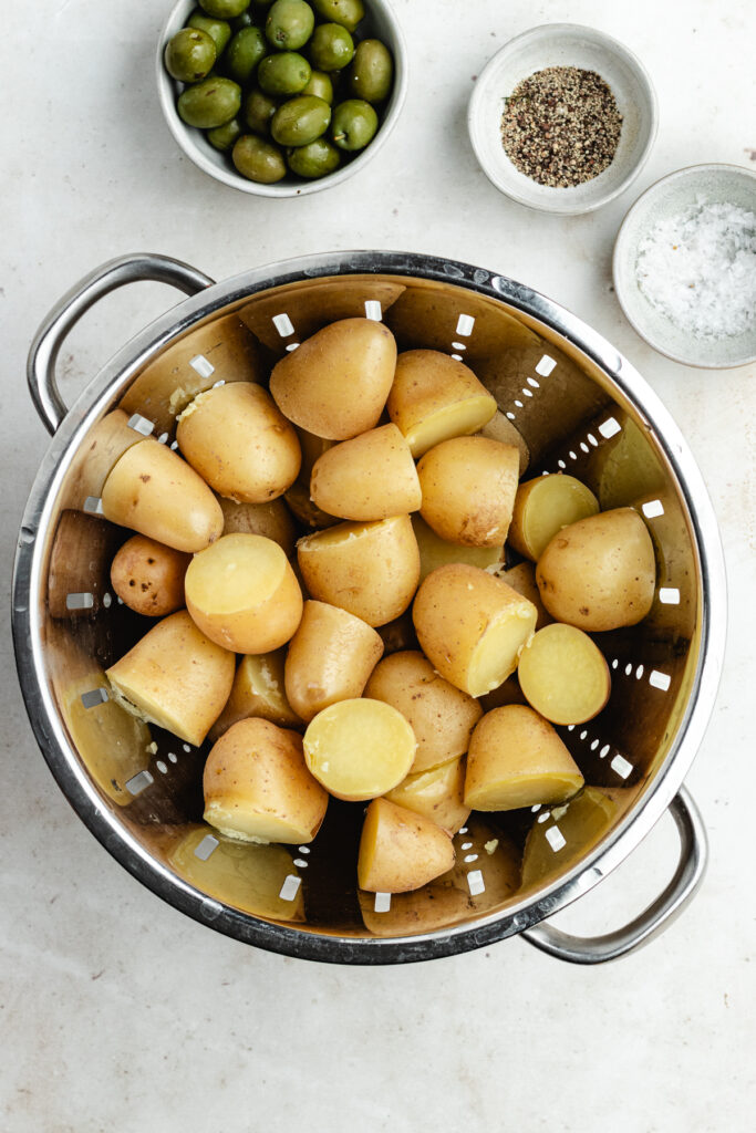 The cooked potatoes in a colander.