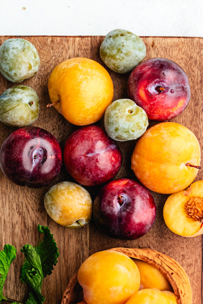 Plums on a cutting board.