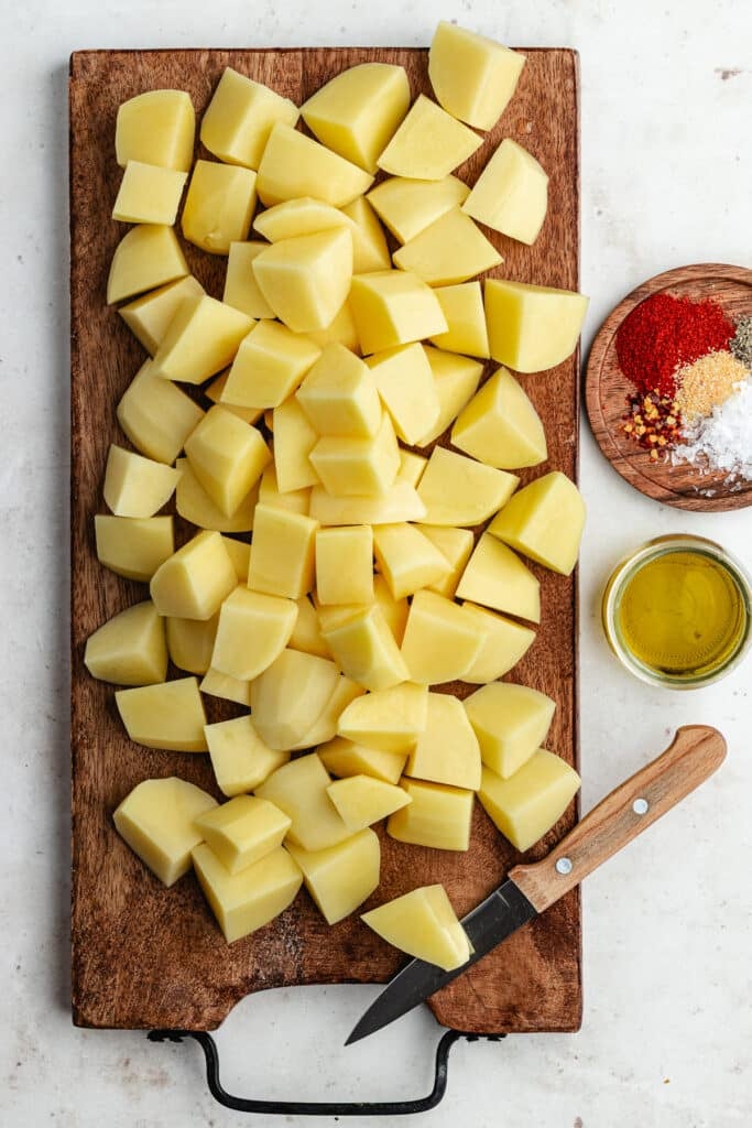 The chopped potatoes on a cutting board.