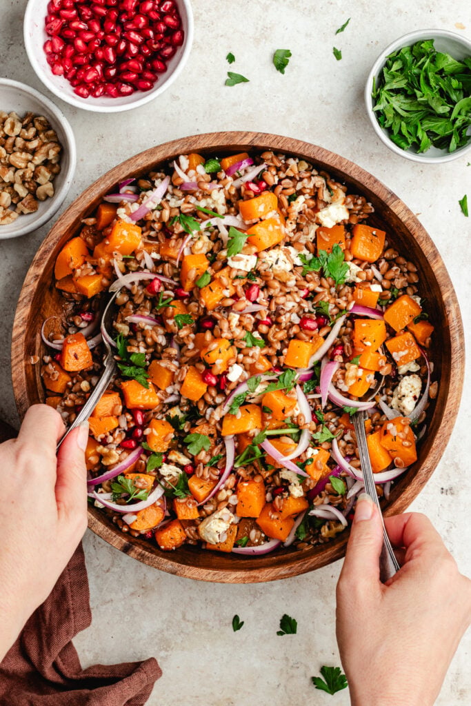 Tossing the salad together.