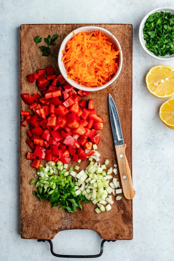 The chopped vegetables on a cutting board.